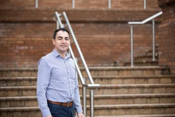 Man stood outside in front of some steps