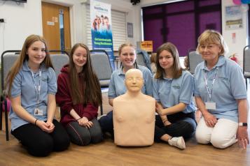Young people performing CPR in class