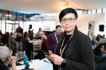 Woman stood in a busy room