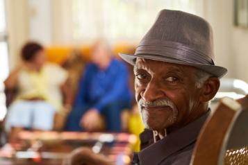 Man smiling at the camera in a care home