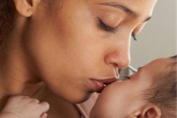 Mother kissing baby