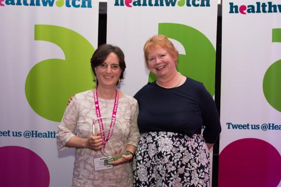 Two women receiving an award