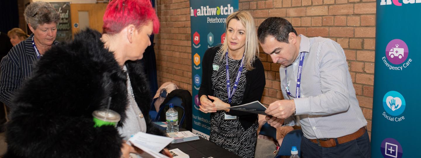 Four people standing at Healthwatch event